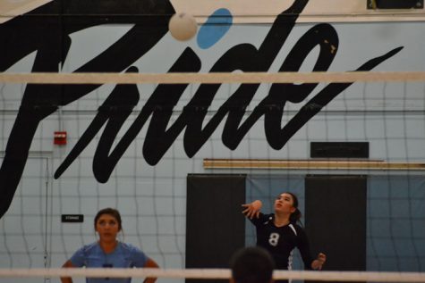 Varsity captain, Maya Chang, 12, strikes the ball over the net versus Rosemead High school. 