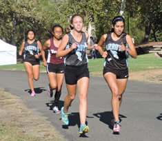 Varsity athlete, Molly Hake (center) keeps up among her fellow runners at the Cluster One Meet. 