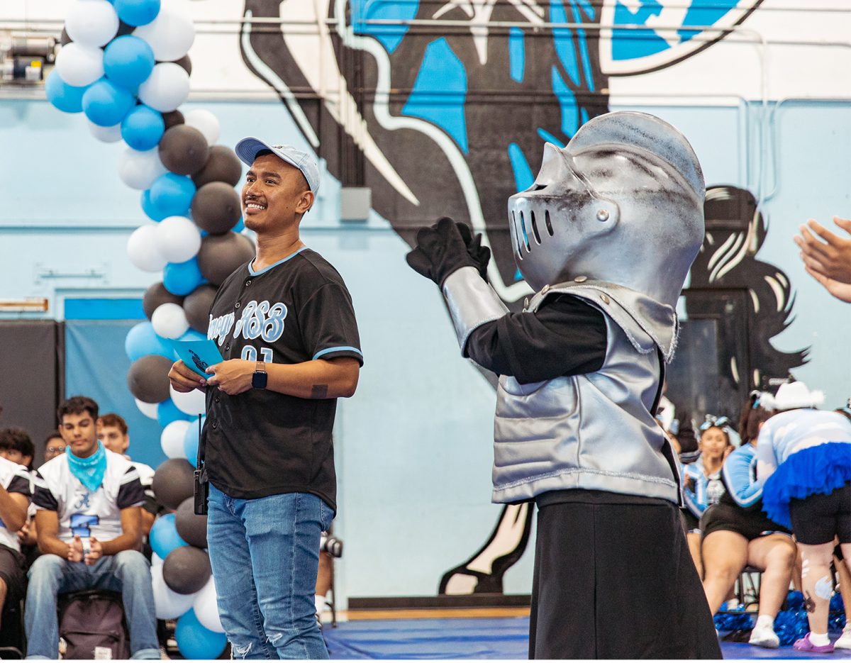 Mr. Dara Sem reacts as the students surprise him by singing Happy Birthday during the Blue, Black and White Assembly. Sems birthday happened to fall on the day of the assembly.
Photo courtesy of YourHS Photography
