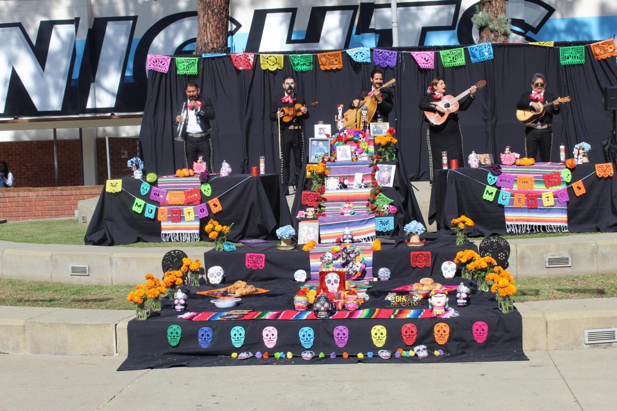 Latino Union celebrating by  making ofrenda and by  having a live mariachi group preform. 